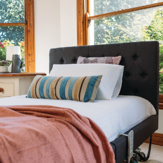 Casero Mode electric floorline bed with pull‑apart design and adjustable profiling features.