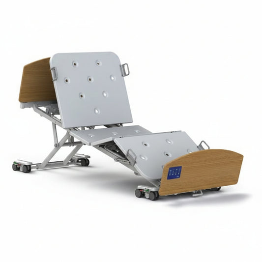 Invacare CS8 floorline electric bed with four‑section mattress platform and adjustable height range.